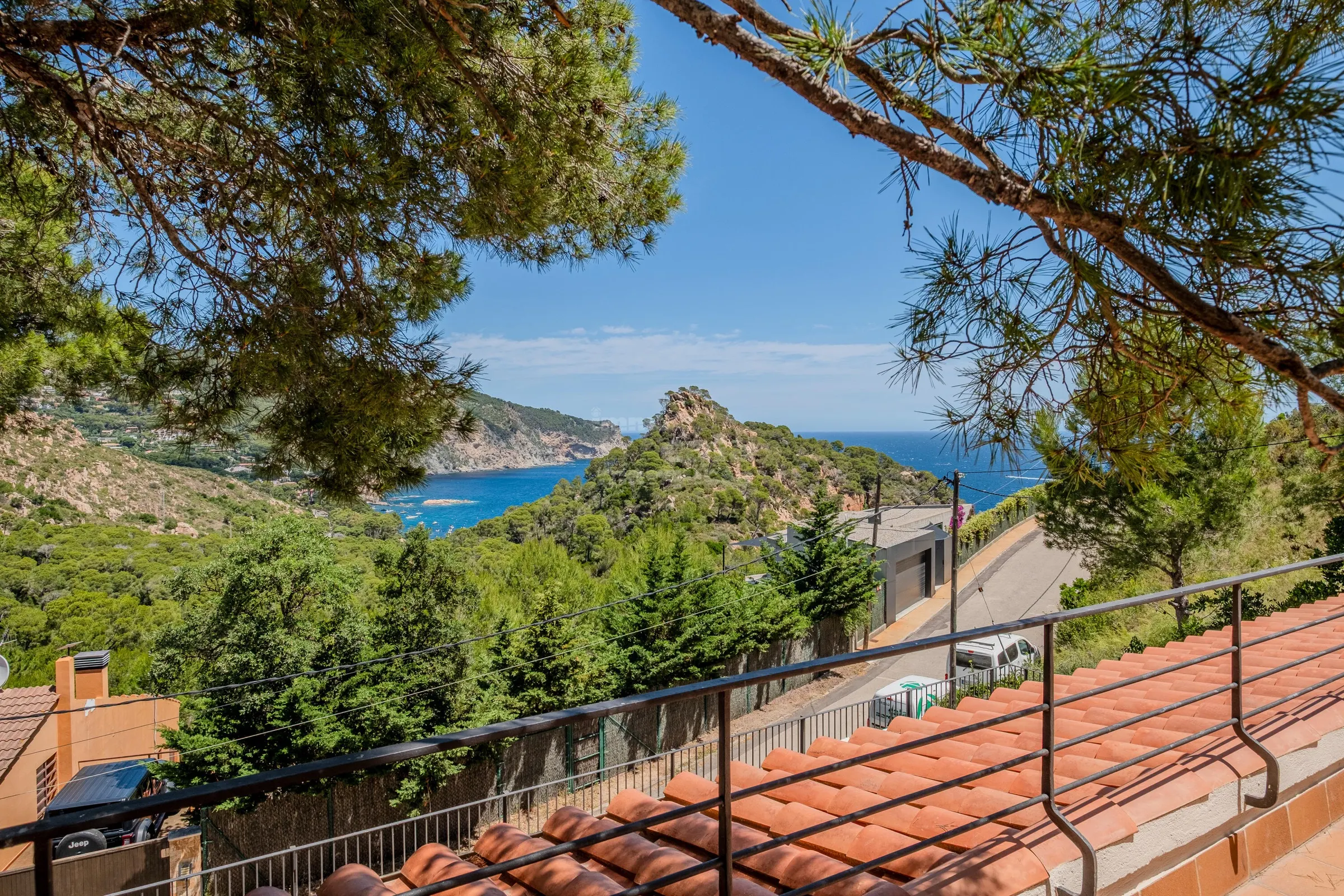 View through the pines over Aiguablava bay, turquoise coves and headland